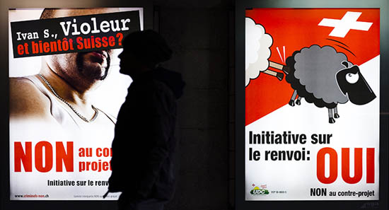 A man walks past posters of the Swiss People's Party (SVP) promoting the initiative to expel foreigners, in Lausanne, November 28, 2010. The posters read 'Ivan S., rapist and soon to be Swiss ?' and 'Yes to the initiative to expel foreigners'.