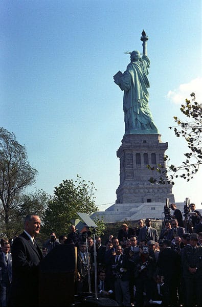 "President Lyndon Johnson visits Liberty Island to sign the Immigration Act of 1965."