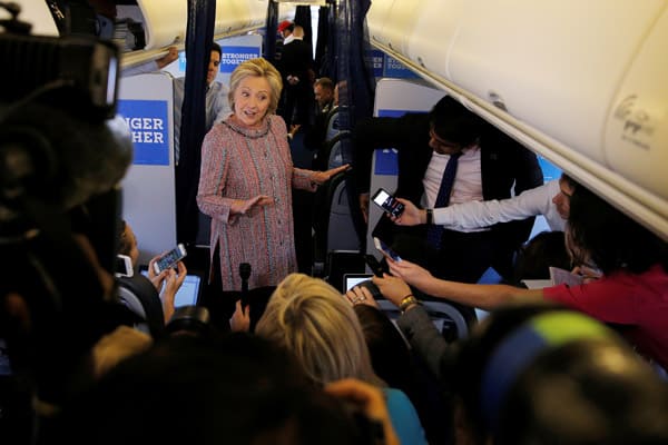 Hillary Clinton greets reporters on her campaign plane. (Credit Image: © Brian Snyder/Reuters via ZUMA Press)