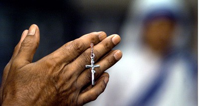 CHRISTIAN HOLDS A CRUCIFIX