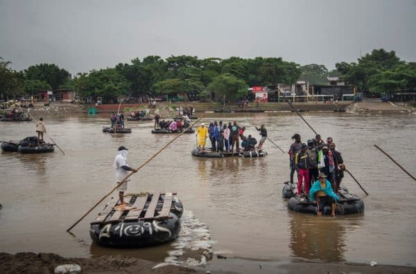 Migrants cross the Suchiate river