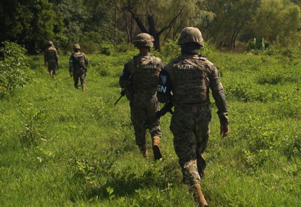 Soldiers of the Mexican Navy patrol by the Suchiate River