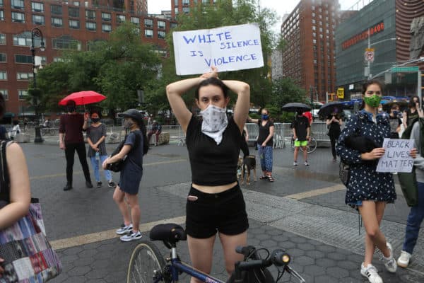 The sign says White Silence is Violence.