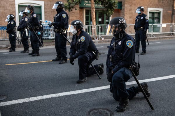 San Francisco: Police Officers kneel at Mission Police Station on June 3, 2020 after the death of George Floyd. (Credit Image: © imageSPACE via ZUMA Wire)