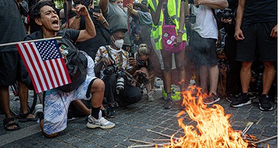 Flags burn in NYC on Independence day