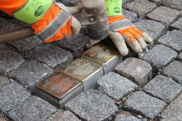 Saxony, Chemnitz: An employee of the municipal building yard lays Stolpersteine on the pavement. The handmade stones by the artist G. Deming are intended to preserve the memory of each individual persecuted person. (Credit Image: © Bodo Schackow / dpa via ZUMA Press)