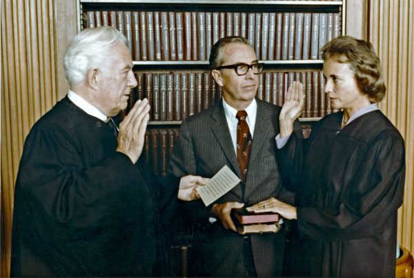 Sandra Day O’Connor is sworn-in as Associate Justice of the United States Supreme Court by Chief Justice Warren Burger in Washington, D.C. on September 25, 1981. Her husband John O’Connor, center, looks on. (Credit Image: © Michael Evans / White House / CNP via ZUMA Wire)