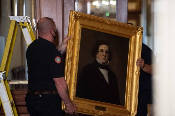 Capitol workers remove a portrait of former House Speaker Howell Cobb of Georgia at the US Capitol in Washington, DC, on June 18, 2020. Four portraits of Confederate former Speakers were taken down from the walls of the Capitol (Credit Image: © Nicholas Kamm / CNP via ZUMA Wire)