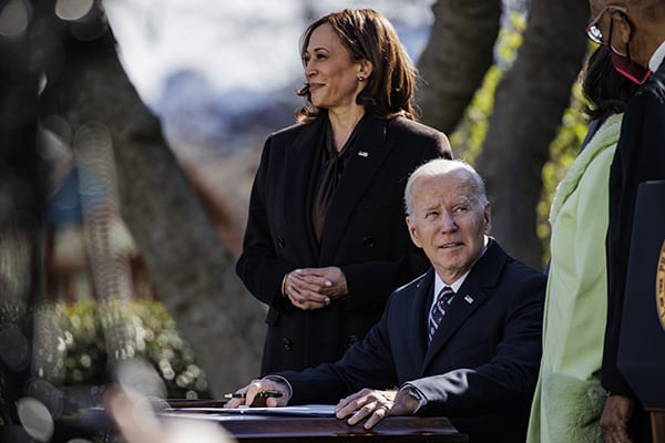 President Joe Biden looks up at Michelle Duster, who is the great-granddaughter of Ida B. Wells, before signing H.R. 55, the ”Emmett Till Antilynching Act” during a ceremony in the Rose Garden on March 29, 2022. (Credit Image: © Samuel Corum – Pool Via Cnp/CNP via ZUMA Press Wire)